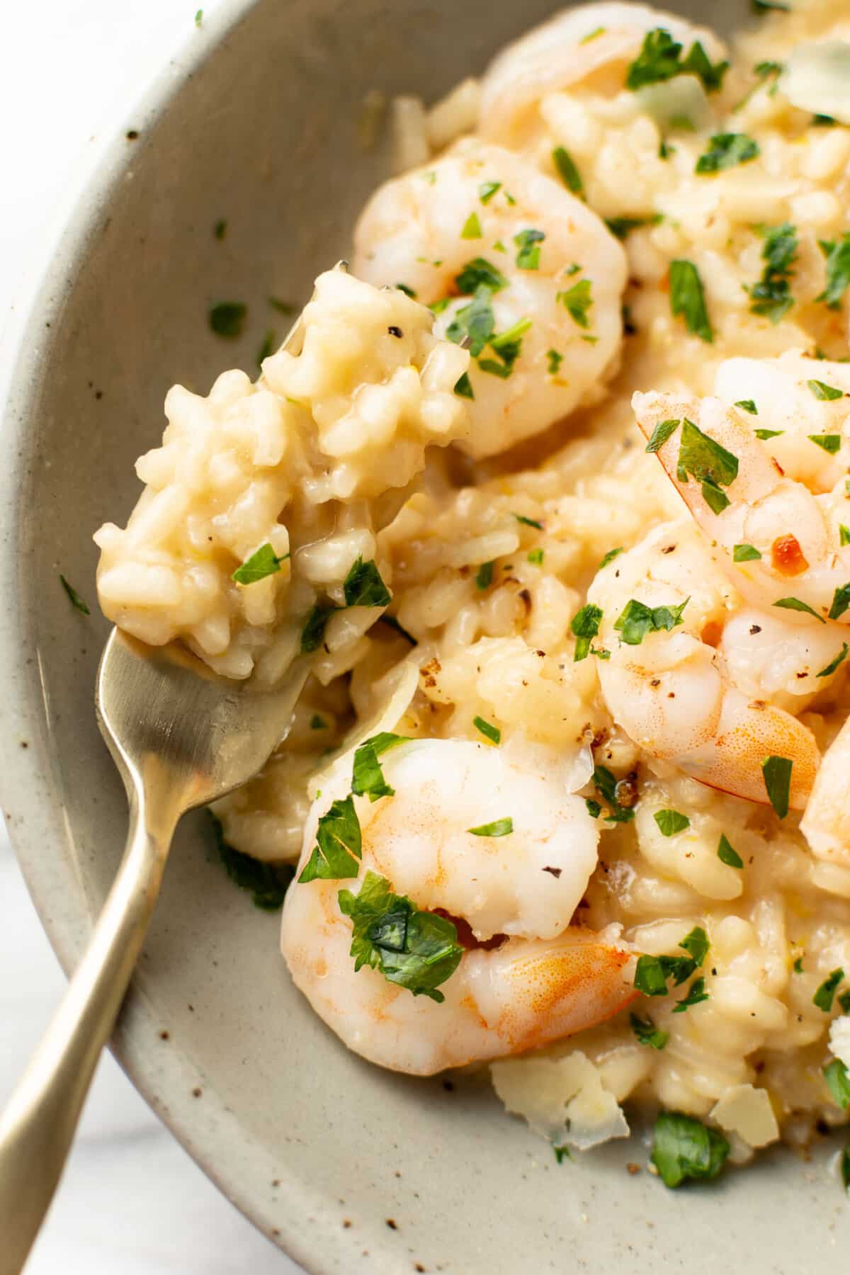 a fork with lemon risotto and garlic shrimp