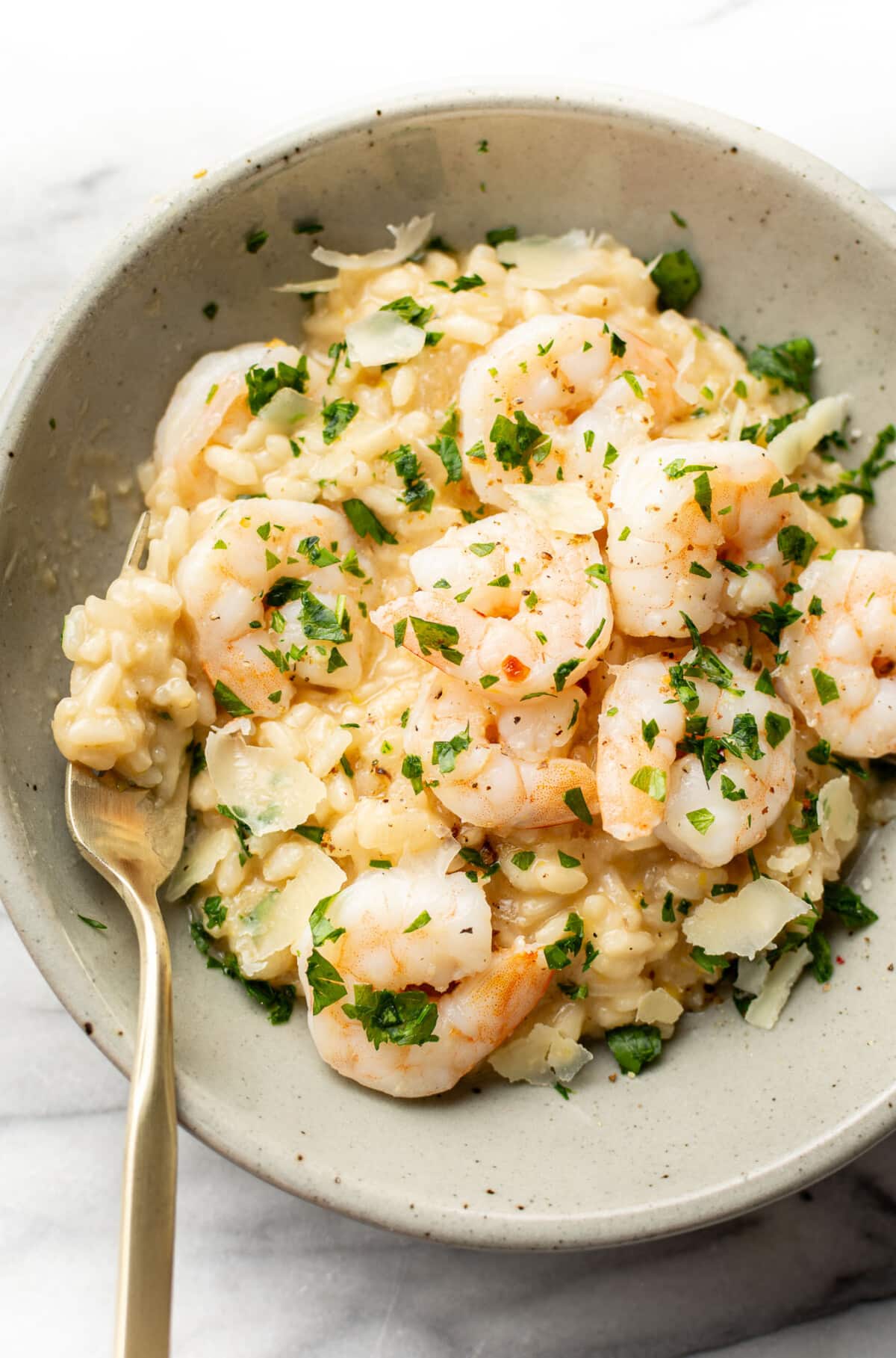 a bowl of lemon and shrimp risotto with a fork