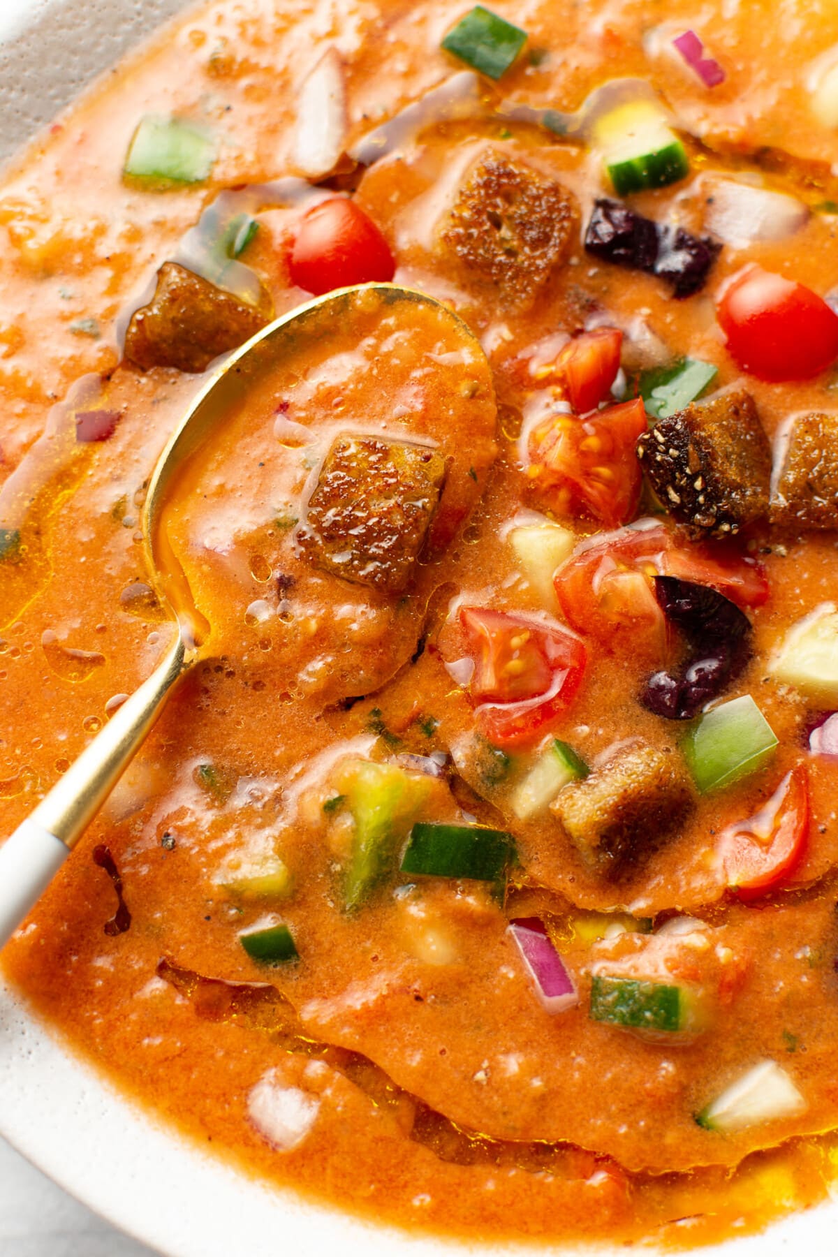 closeup of a bowl of gazpacho with a spoon