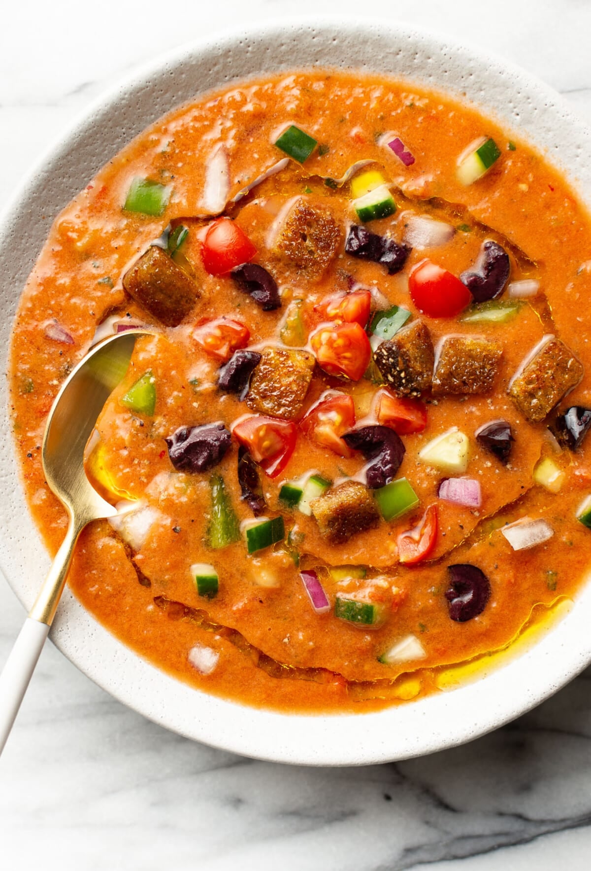a bowl of gazpacho with a spoon