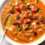 a bowl of gazpacho with a spoon