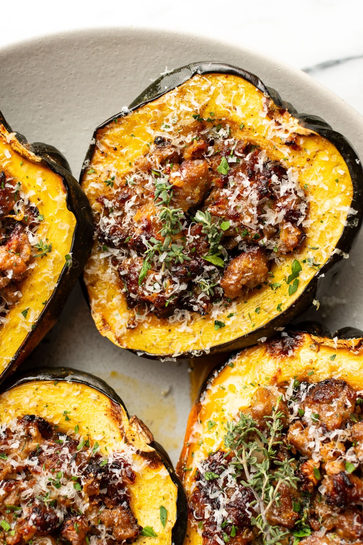a plate with sausage stuffed acorn squash
