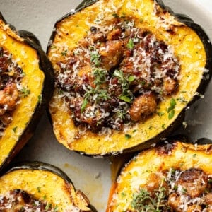 a plate with sausage stuffed acorn squash