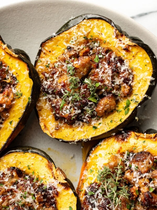 a plate with sausage stuffed acorn squash