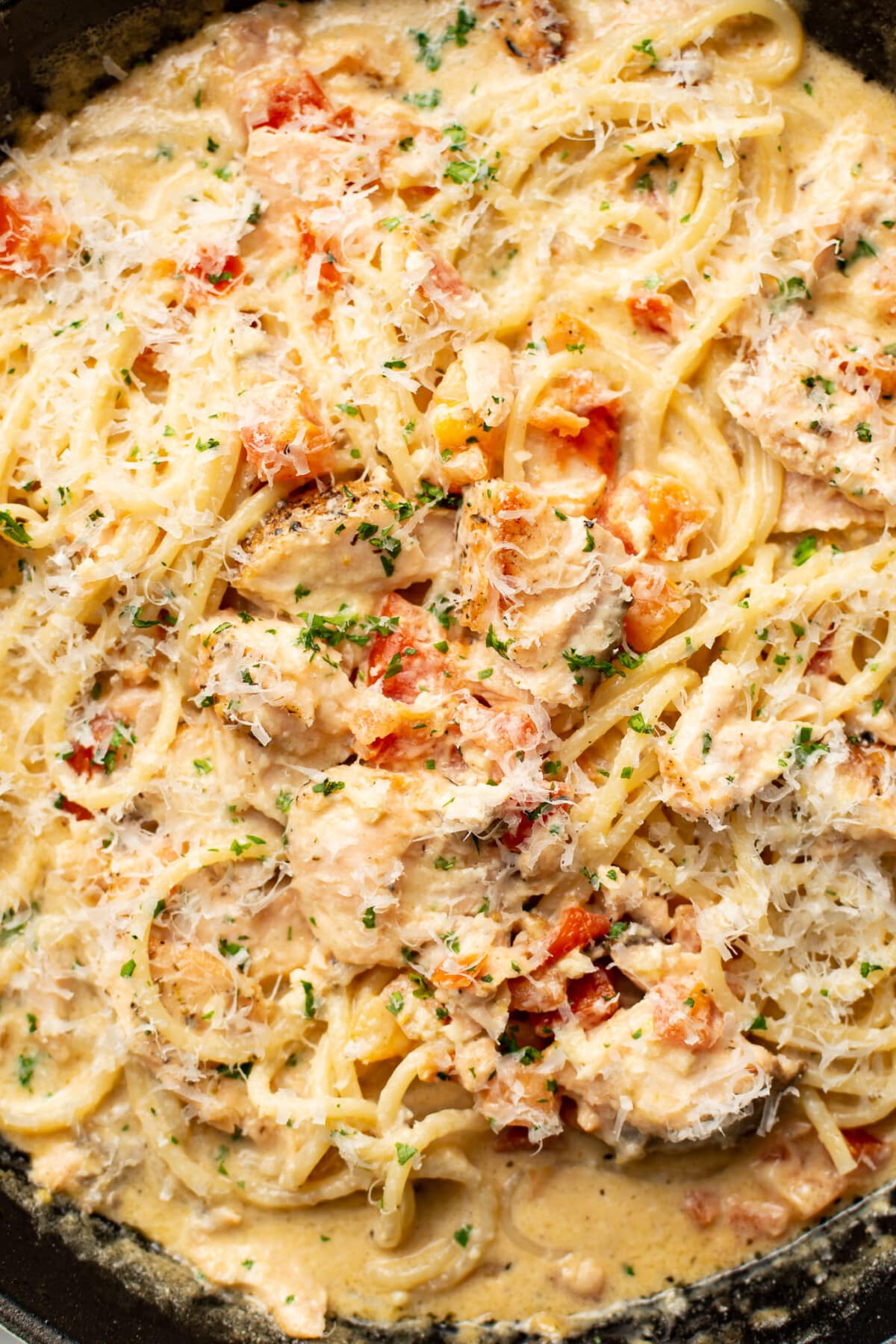 closeup of a skillet with creamy tomato salmon pasta