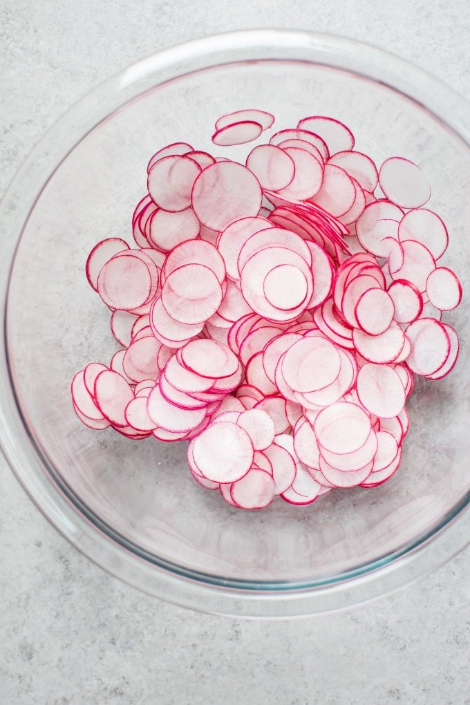 glass bowl with sliced radishes