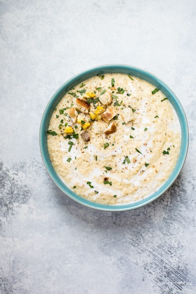teal bowl with vegan roasted corn and cauliflower soup