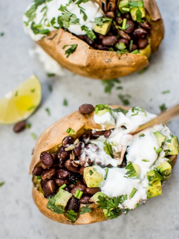 These healthy stuffed sweet potatoes make a fabulous light meal or side! Black beans with a quick lime dressing, Greek yogurt, avocado, and chives top these flavor-packed bundles of deliciousness.