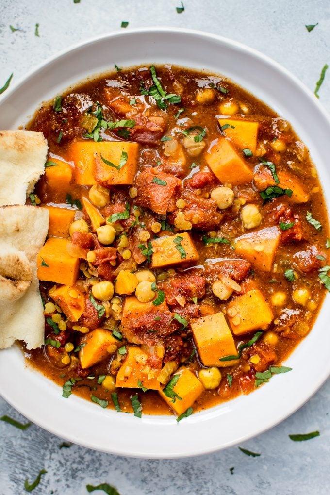 close-up of crockpot vegan sweet potato curry in a white bowl