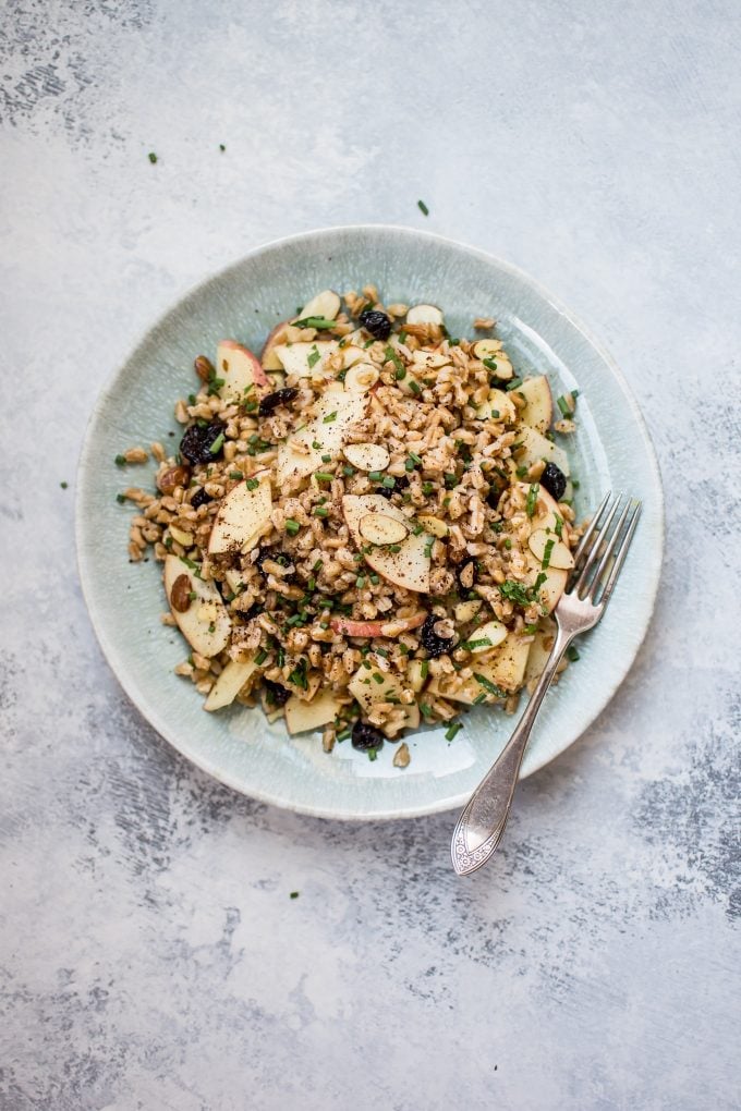 teal plate with vegan farro salad and a fork