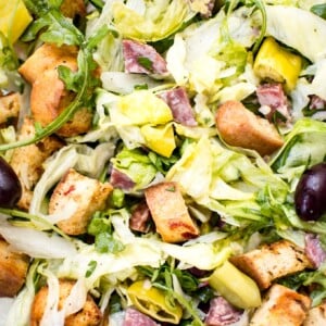 This Italian chopped salad recipe is easy, fast, and fresh. Salami, homemade croutons, and pepperoncini peppers make this one flavorful salad!