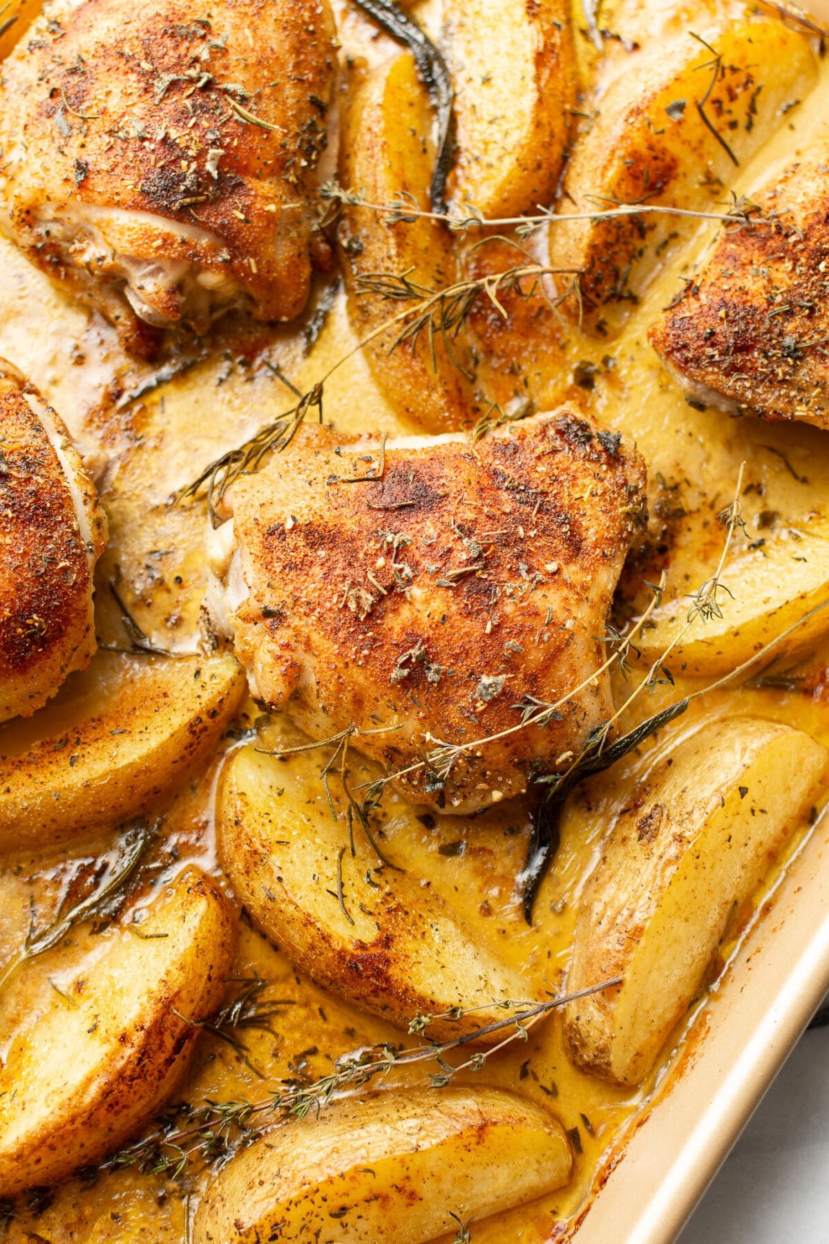 a sheet pan with chicken thighs and potatoes