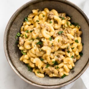 This easy Instant Pot hamburger mac and cheese is total comfort food that's ready in only 30 minutes! No draining of the macaroni is needed, and it's all made right in your electric pressure cooker. This beefy macaroni and cheese is perfect for large families and weeknight meals. You'll love the simple Tex-Mex spice blend that flavors the meat.