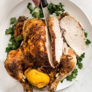 This easy Instant Pot whole chicken recipe is fast, simple, healthy, and makes the best tender chicken. This electric pressure cooker whole chicken is great for a family dinner or to have chicken meat ready for meals throughout the week! The chicken can be stuffed with lemon for extra flavor. Use the leftovers to make stock or bone broth. You can even use frozen chicken in this recipe.