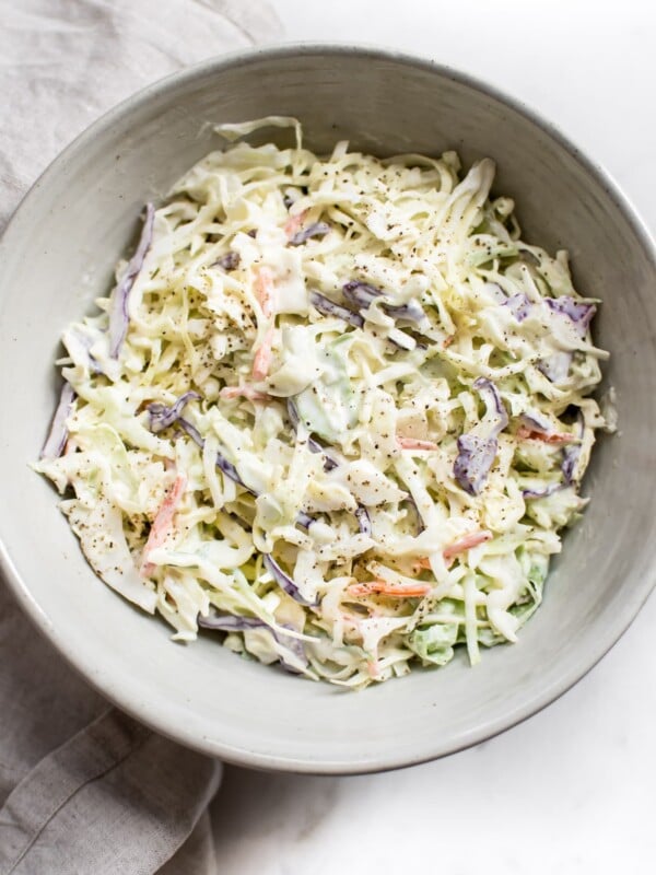 This simple coleslaw recipe has a delicious creamy homemade dressing that's perfectly tangy and sweet. The best classic coleslaw that is perfect for pulled pork, picnics, or BBQs. 