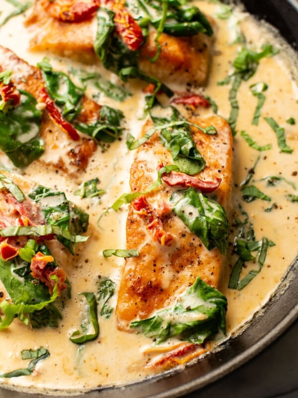 a skillet with creamy tuscan salmon