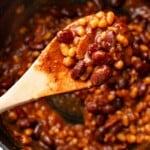 baked beans with a wooden spoon