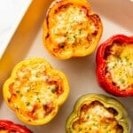 a baking dish with sausage stuffed peppers