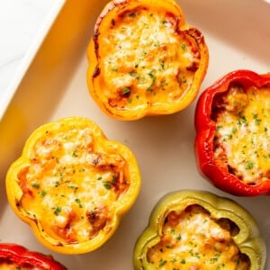 a baking dish with sausage stuffed peppers