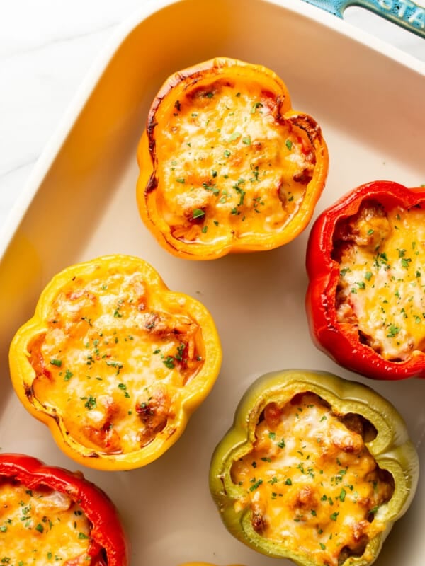 a baking dish with sausage stuffed peppers