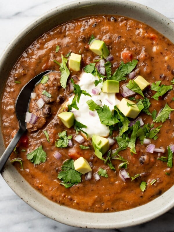 a bowl of black bean soup with a spoon
