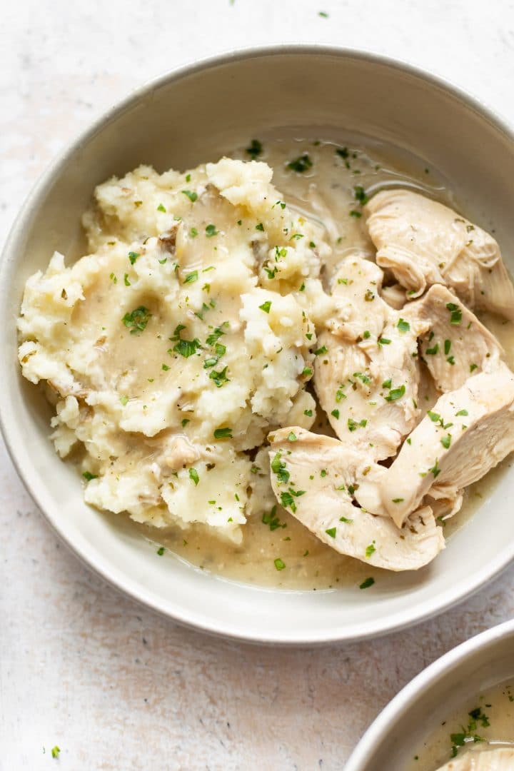 close-up of slow cooker chicken and gravy over mashed potatoes