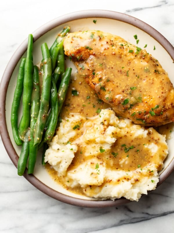 a plate with honey mustard chicken, green beans, and mashed potatoes