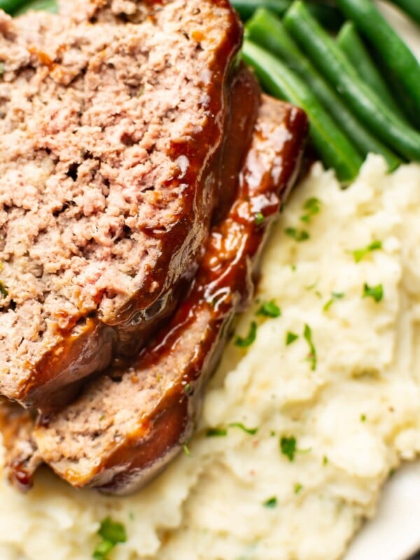 closeup of meatloaf, green beans, and mashed potatoes