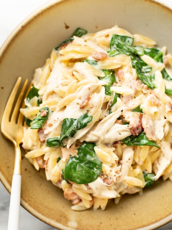 a bowl of chicken bacon ranch orzo with a fork