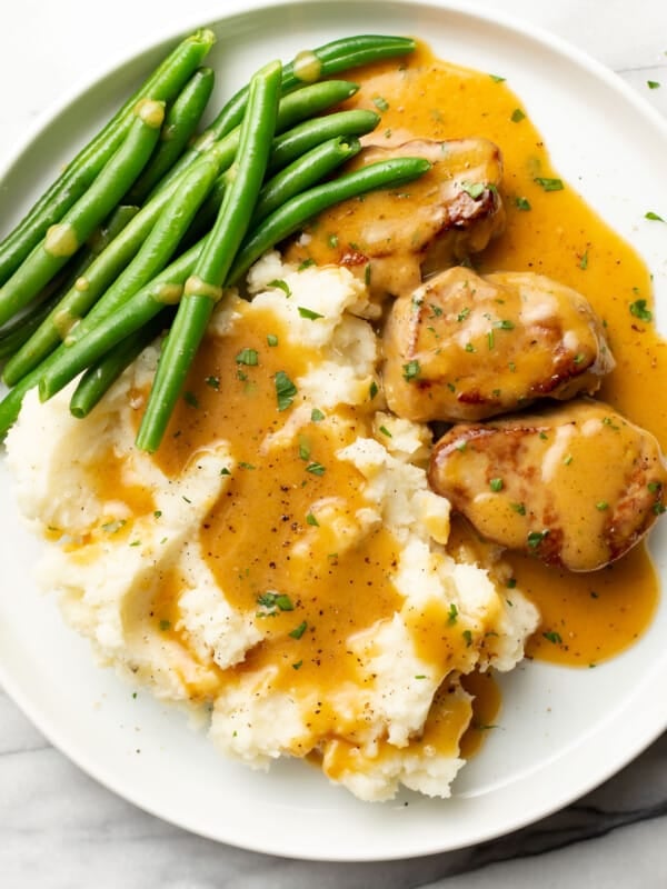 a plate with honey mustard pork tenderloin, green beans, and mashed potatoes