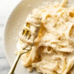 a bowl of cajun fettuccine alfredo with a fork