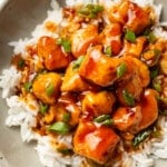 a bowl of firecracker chicken over rice