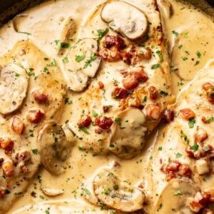 closeup of a skillet with creamy pancetta and mushroom chicken