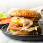 a burger on a plate with homemade burger sauce