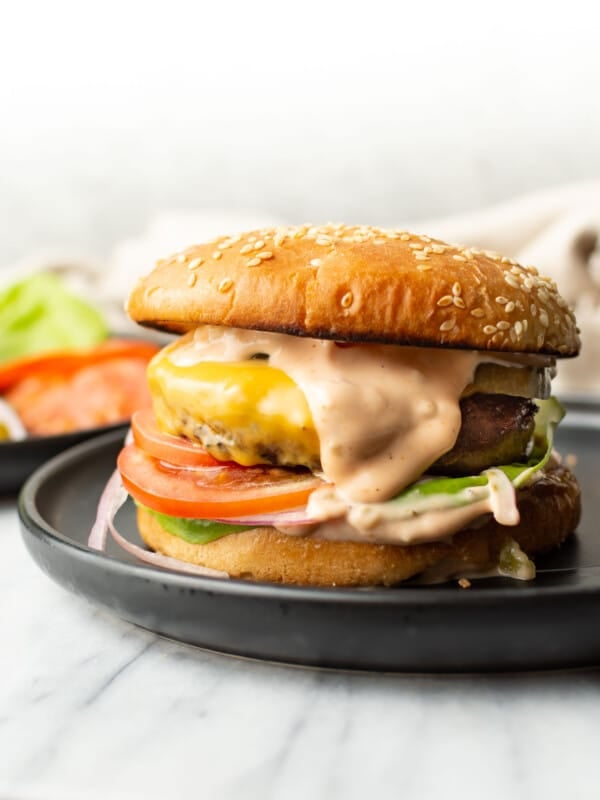 a burger on a plate with homemade burger sauce