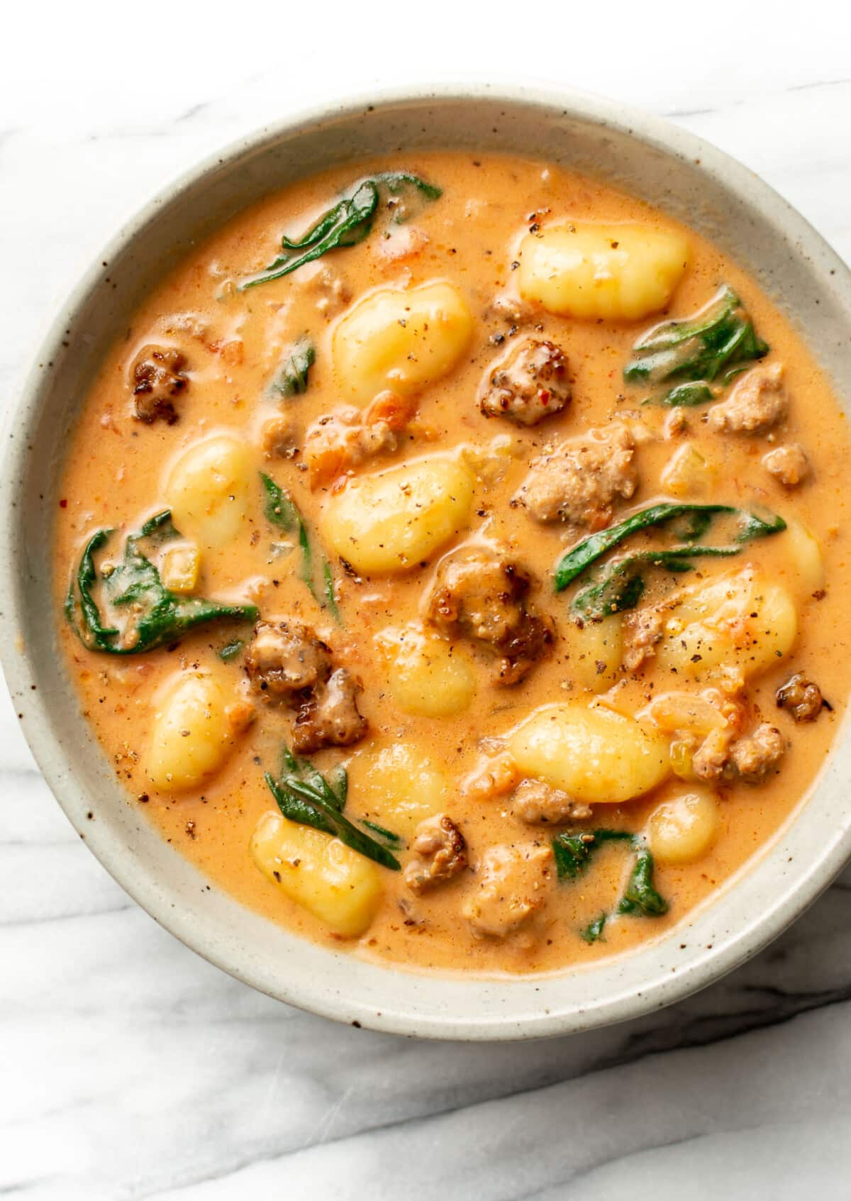 a bowl of creamy italian sausage gnocchi soup