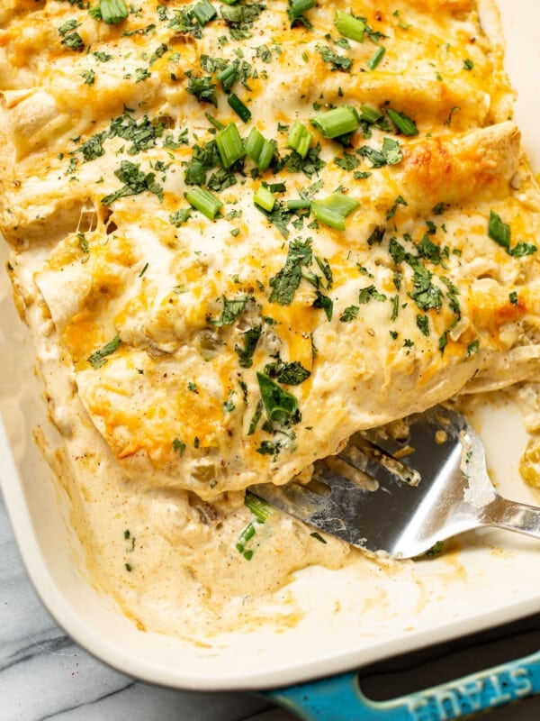 a baking dish with chicken enchiladas