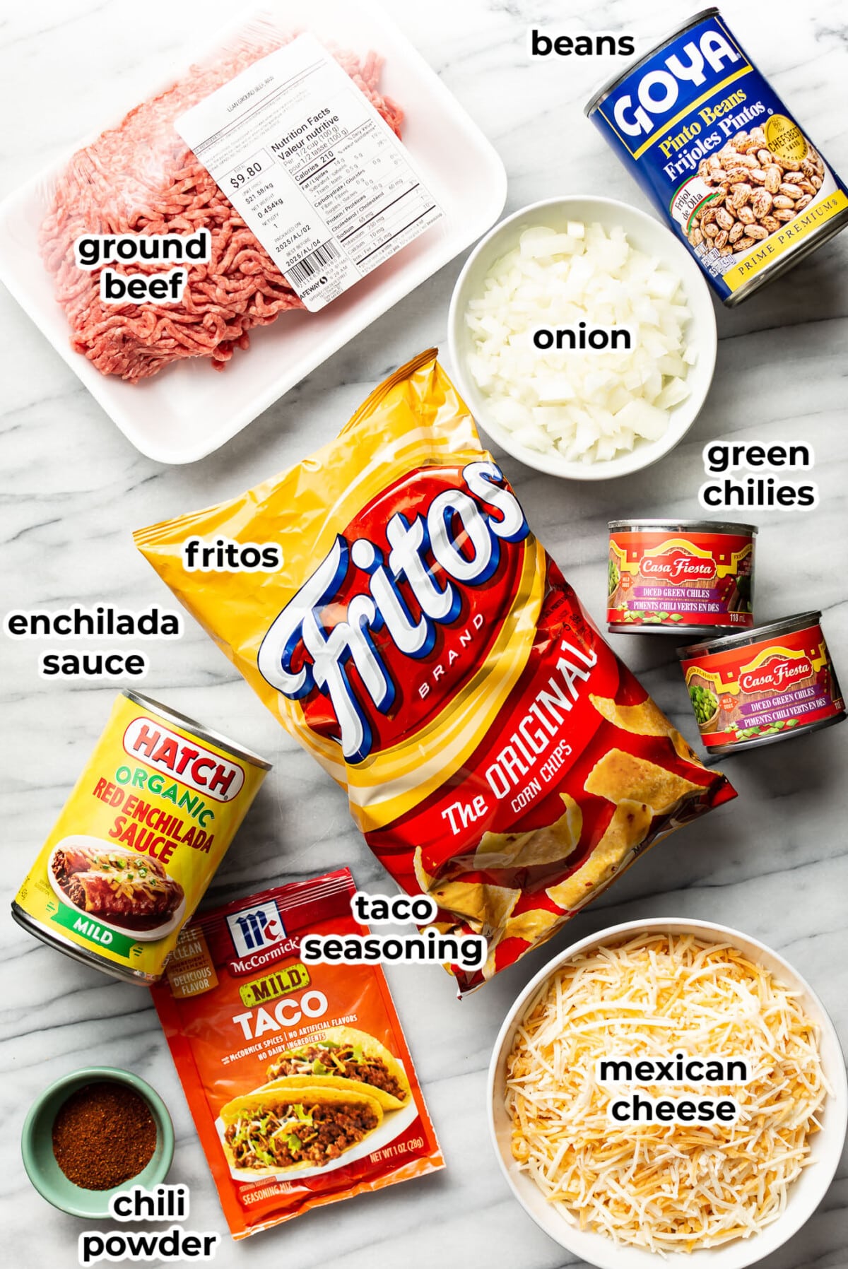 ingredients for frito pie on a marble surface