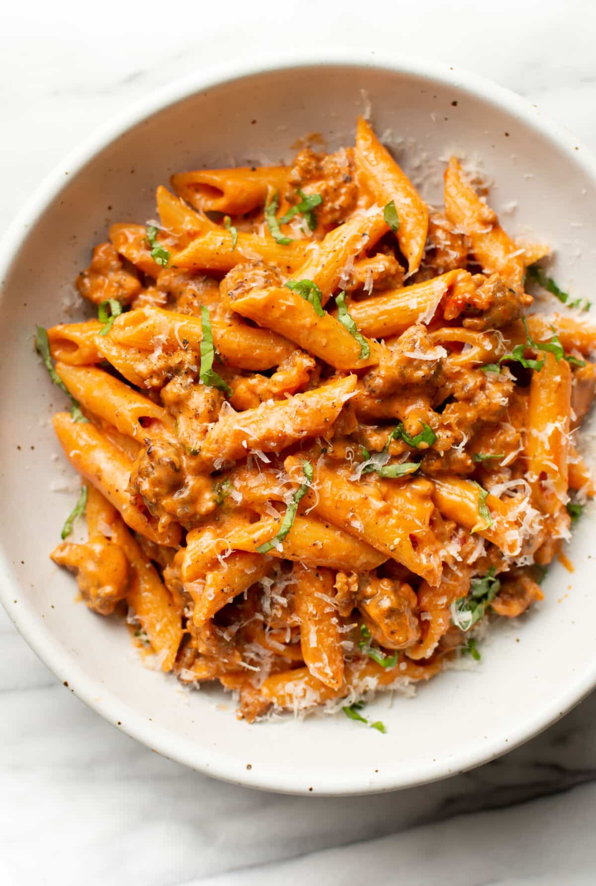 a bowl of penne alla vodka with sausage