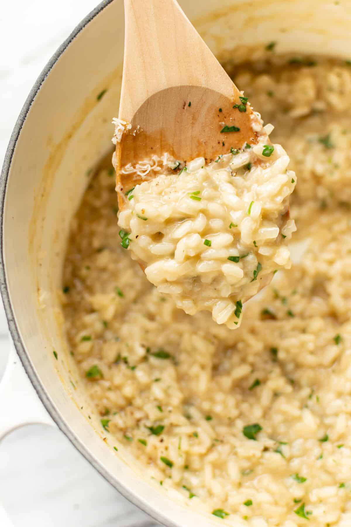 a wooden spoon with risotto