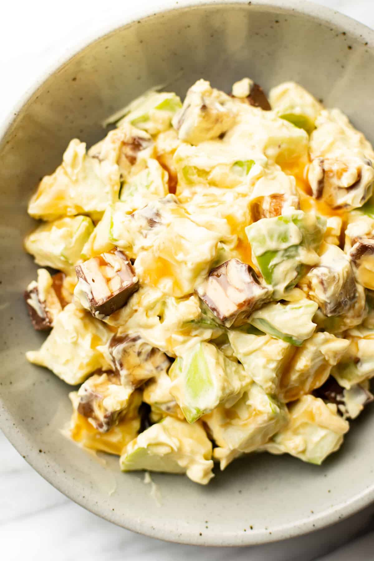 a bowl of snickers salad