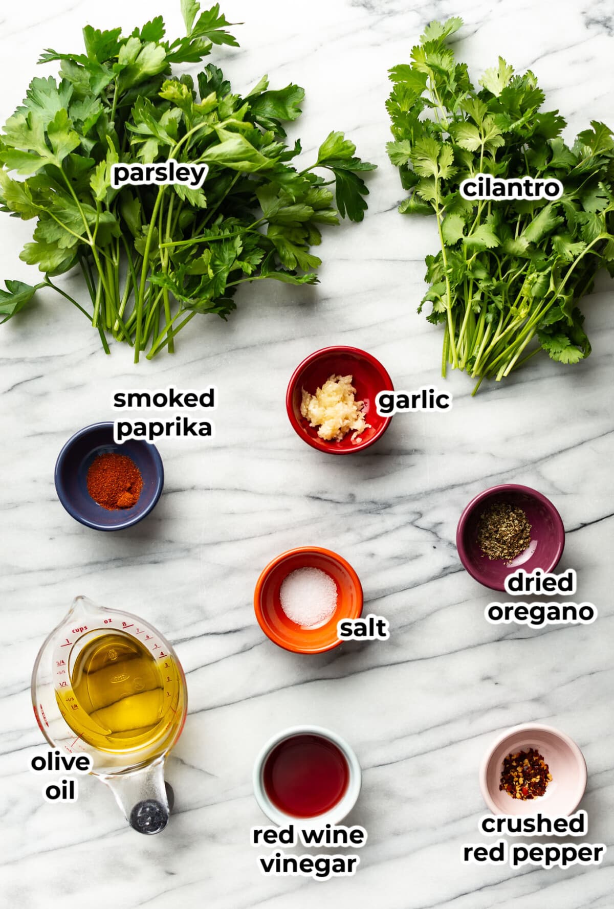 ingredients for chimichurri sauce in prep bowls