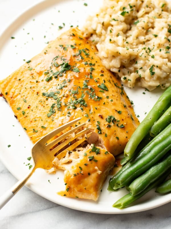 a plate with arctic char, risotto, green beans, and a fork