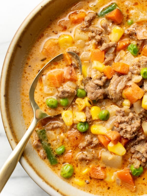 a bowl of shepherd's pie soup with a spoon