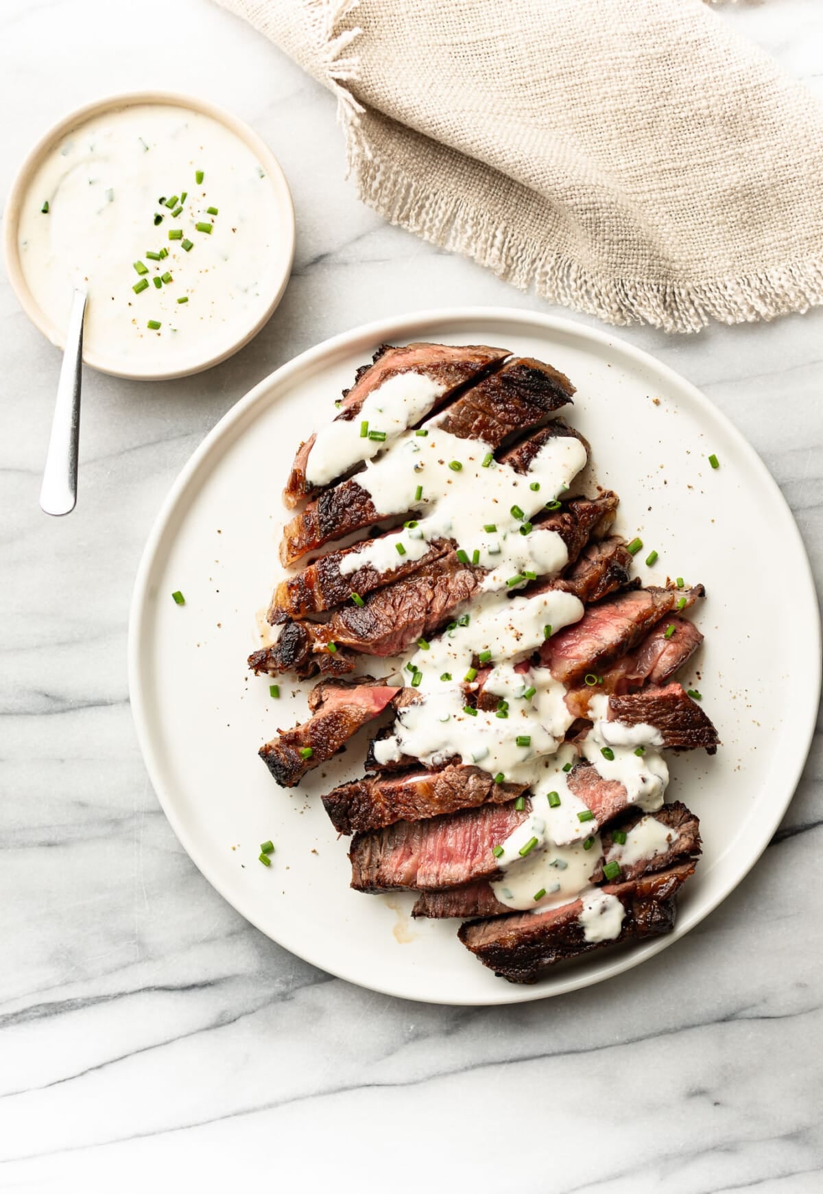a plate with steak and creamy horseradish sauce