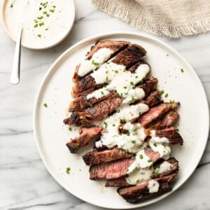 a plate with steak and creamy horseradish sauce