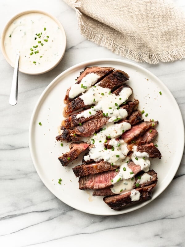 a plate with steak and creamy horseradish sauce