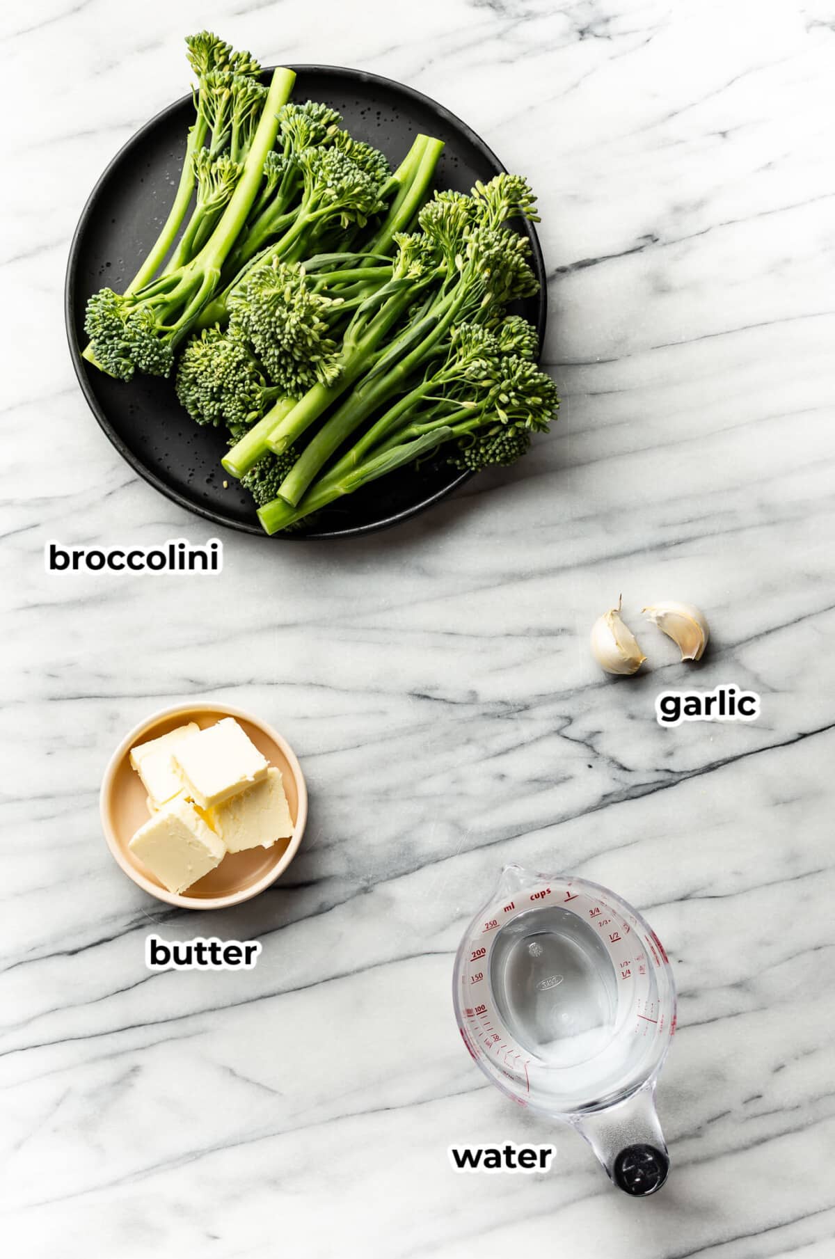 ingredients for cooking broccolini in prep bowls