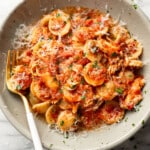 a bowl of chicken fra diavolo pasta with a fork