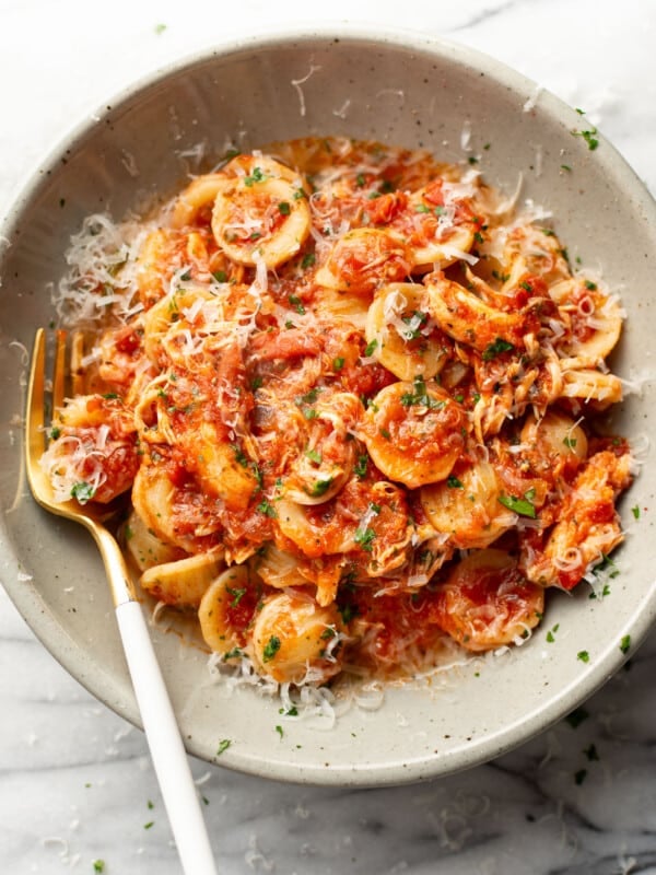 a bowl of chicken fra diavolo pasta with a fork